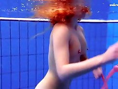 Curly hair redhead swims and looks sexy