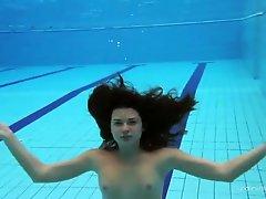 Her slender teen body is perfect under the water