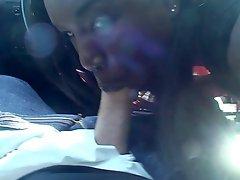 Refined ebony babe with long hair gets her face fucked in the car