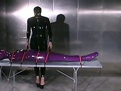 Submissive tied up chick in latex stuff gets slapped by horny domme