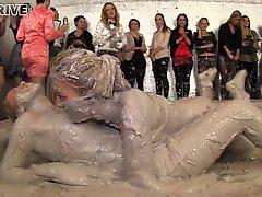 Mud wrestling hotties end up naked and feeling each other up