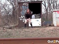 Cute girl walks the railroad tracks and pees