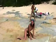 Amia and Tanner play on the sand naked in this lesbian beach scene