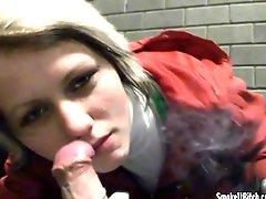 Sexy girl smokes cigarette and sucks cock