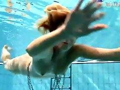 Lanky naked girl swims like a fish