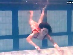 Hairy pussy girl in red swimsuit under water