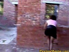 Lady wearing black stockings lifts skirt and pees