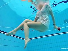 Teen swimming in a lace dress has sexy tits
