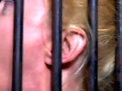 Bosomy blonde Darling is trained for brutal deep throat in head cage