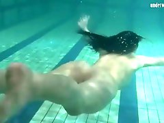 Smooth and slender teen swims in the pool