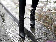 Hooker waiting in louboutin boots in street