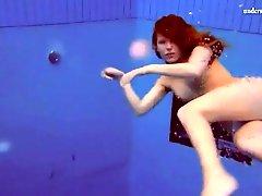 Curly red hair girl swims in her panties