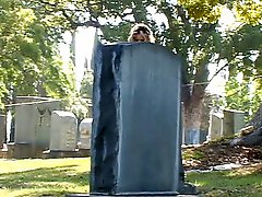 Playing with her pussy in the cemetery